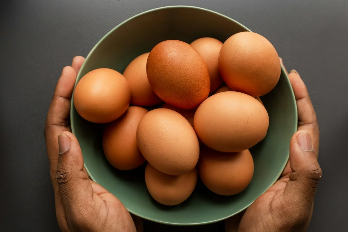 Huevos de granja frescos en recipiente, alérgeno alimentario común en pediatría y adultos